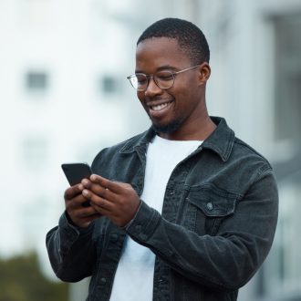 Black,Man,,Phone,And,Smile,In,City,Reading,Email,,Social